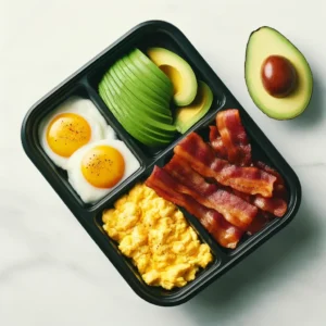 A food prep tray containing a ketogenic meal of eggs, bacon and avocado