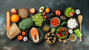 A variety of foods suitable for the Mediterranean diet, including salmon, whole grain bread,fruits, vegetables and cheese.