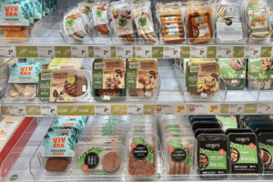 Grocery shelves filled with ultra-processed vegan packaged foods.